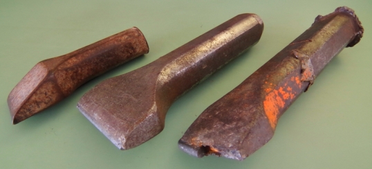 Rusty worn out tools including steel chisel